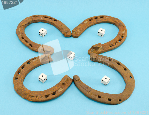 Image of clover retro horse shoes gamble dice on blue 