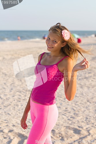 Image of cheerful teen girl on the beach