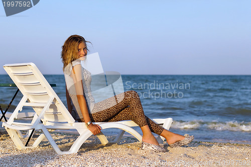 Image of girl sitting on a lounge chair