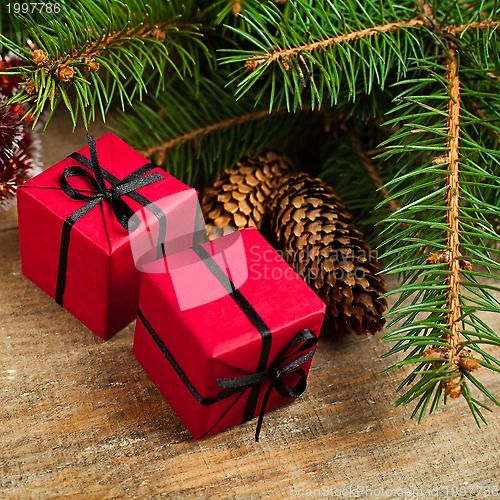 Image of christmas fir tree with pinecones and decorative boxes