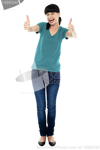Image of Amused woman gesturing double thumbs up