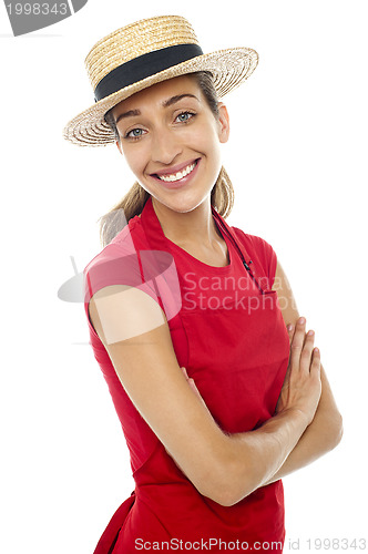 Image of Cheerful baker woman wearing straw bowler hat