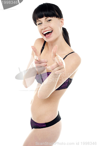 Image of Pretty brunette in bikini gesturing gotcha