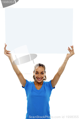 Image of Woman holding up blank white ad board