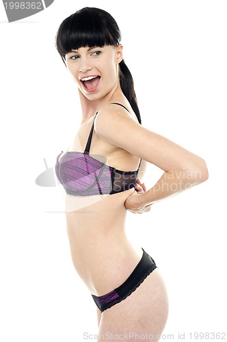 Image of Ravishing woman unhooking her brassiere
