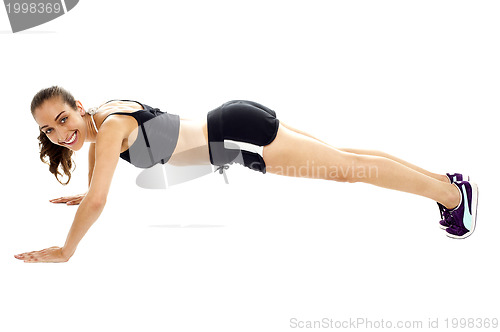 Image of Attractive young brunette doing push ups
