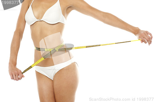 Image of Fit woman measuring her waist, cropped image