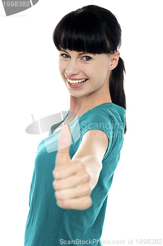 Image of Attractive woman showing thumbs up gesture