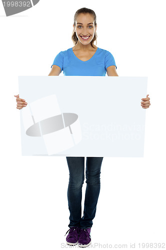 Image of Trendy woman displaying blank billboard