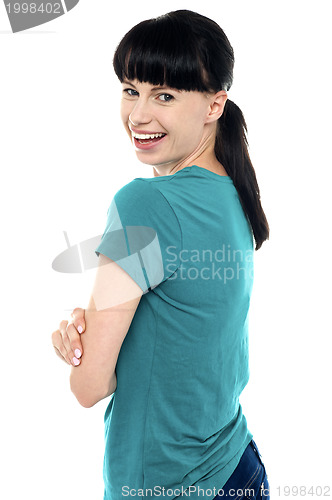 Image of Gorgeous charming female turning and looking at camera