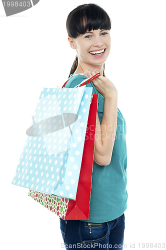 Image of Girl with shopping bags tossed over her shoulders
