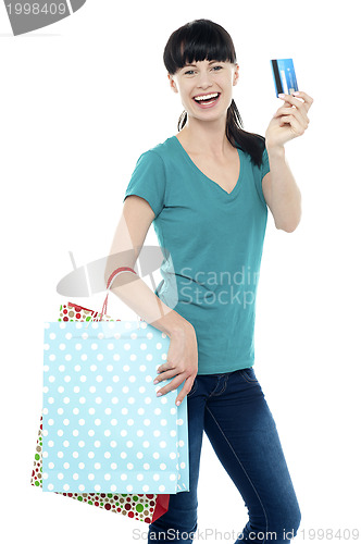 Image of Shopaholic woman holding her cash card up