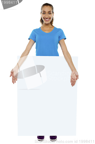 Image of Joyous lady standing behind blank banner ad