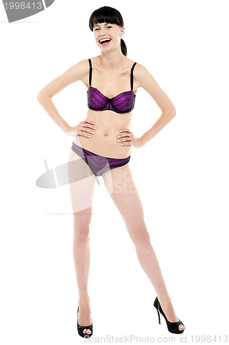 Image of Stunning lady posing in lingerie, laughing heartily
