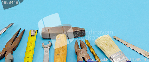 Image of various construction work tools on blue 