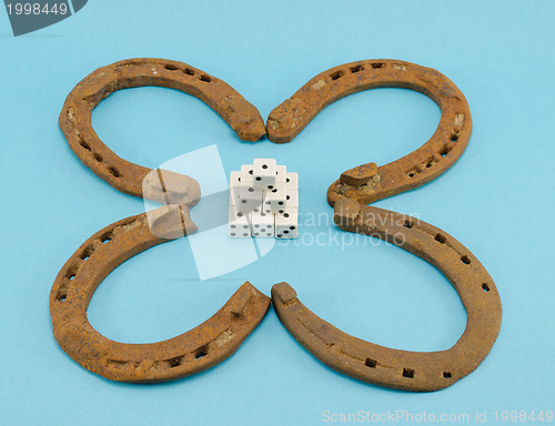 Image of clover retro horse shoes gamble dice on blue 
