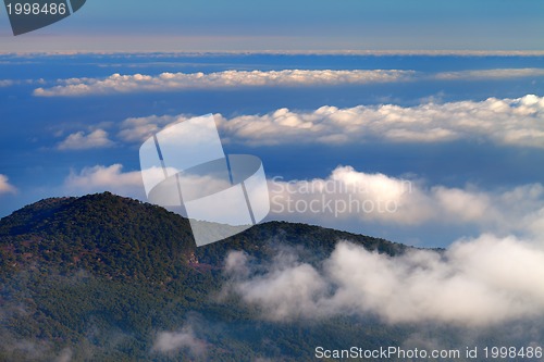 Image of Hill and sea in clouds