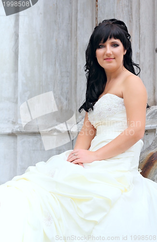 Image of Girl in the wedding dress sitting