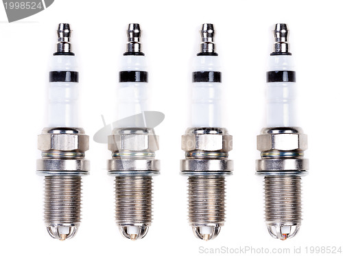 Image of Four spark plugs. Isolated on white.