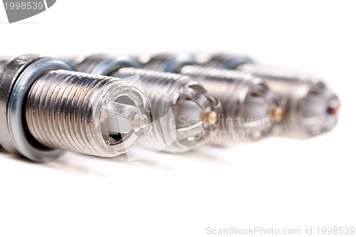 Image of Four automobile spark plugs closeup