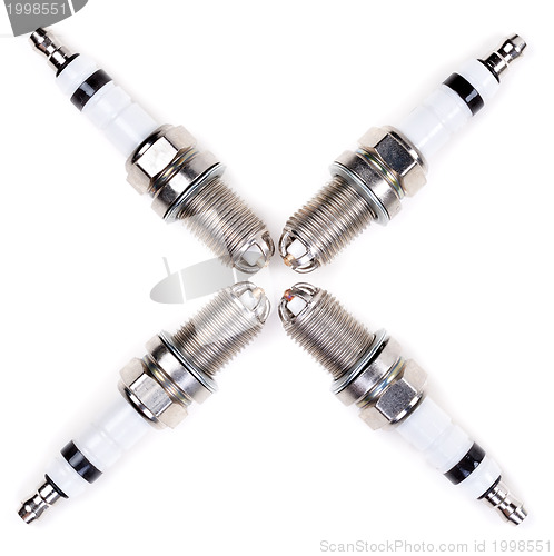 Image of Four spark plugs in the form of a cross