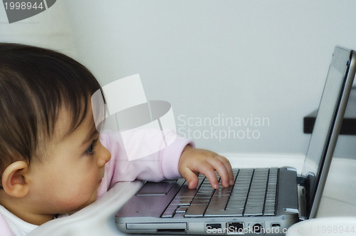 Image of 1 Year Baby Girl trying to use her Netbook