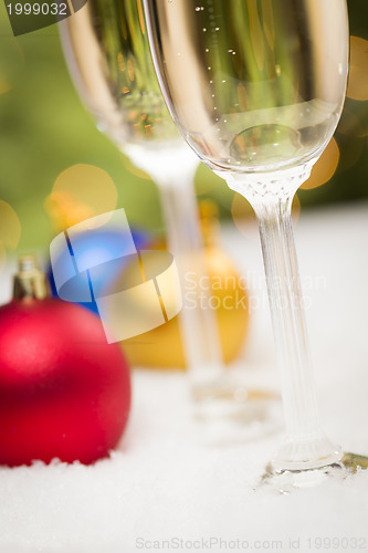 Image of Christmas Ornaments and Champagne Glasses on Snow