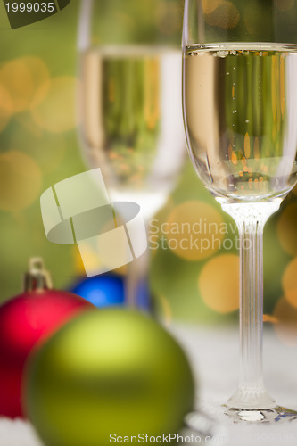 Image of Christmas Ornaments and Champagne Glasses on Snow