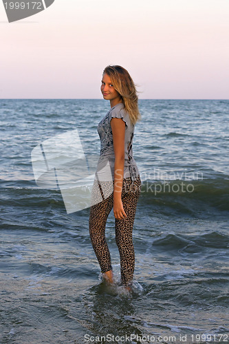 Image of girl walks into the sea