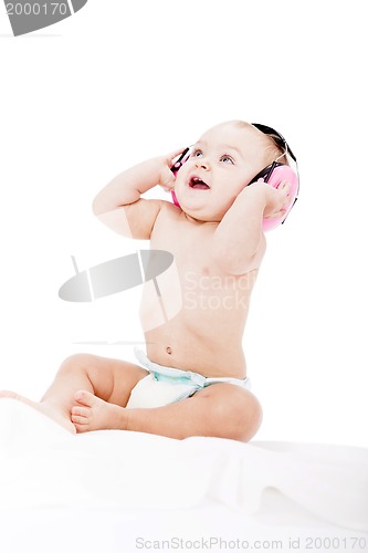 Image of cute little baby with protection earphones 