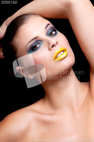 Image of woman with extreme colorfull make up in blue and yellow