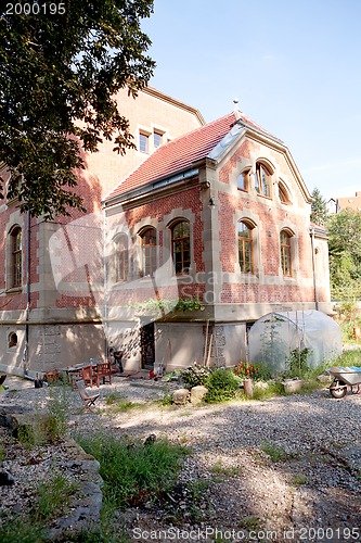 Image of big old red building house with garden