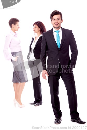 Image of young successful business man in front a group