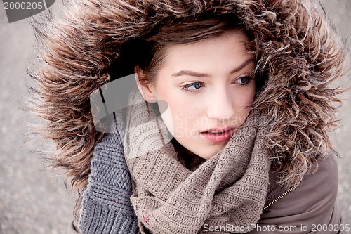 Image of young woman with jacket coat and hood in winter 