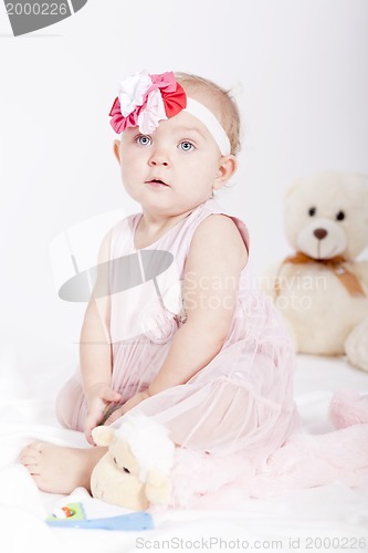 Image of pretty little baby girl in pink dress