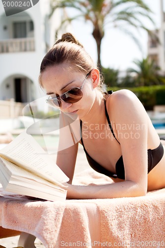 Image of sexy woman in bikini relax on sunlounger sunbathing