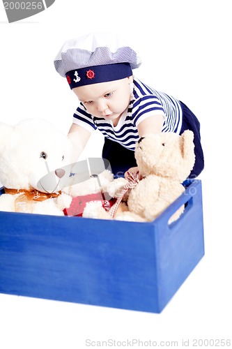 Image of cute little baby in sailor fashion playing 