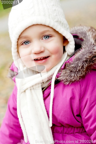 Image of cute little girl with hat and scarf in autumn winter 