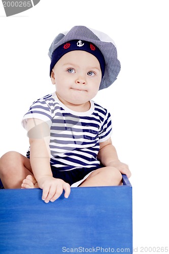 Image of cute little baby in sailor fashion playing 