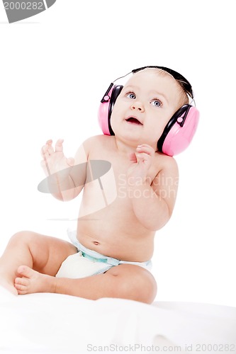 Image of cute little baby with protection earphones 