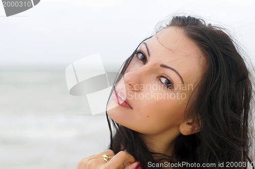 Image of cute young woman on the beach