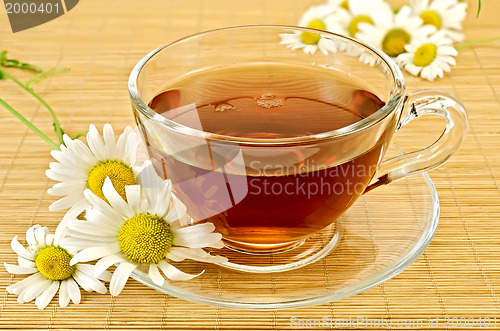 Image of Herbal tea with camomiles on a bamboo