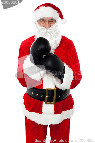 Image of Aged cheerful Santa wearing boxing gloves