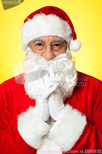 Image of Thoughtful Santa Claus wearing eyeglasses