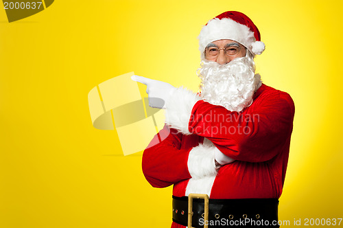 Image of Kris Kringle gesturing towards the copy space area