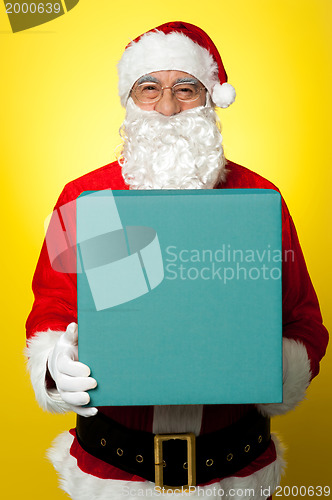 Image of Isolated smiling Santa holding gift box