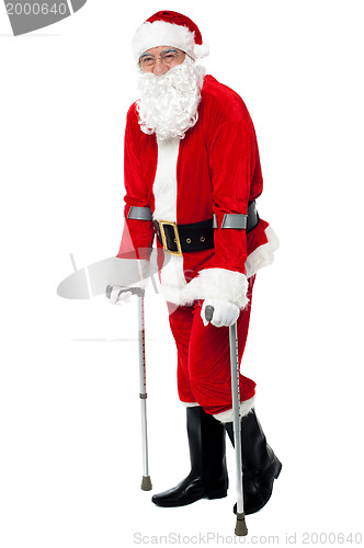 Image of Santa walking with the help of crutches