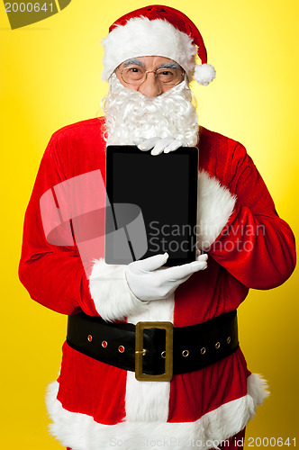 Image of Kris Kringle presenting new updated tablet pc