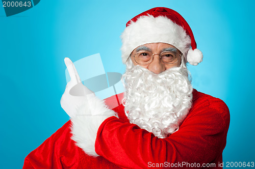 Image of Father Christmas pointing away, copy space area