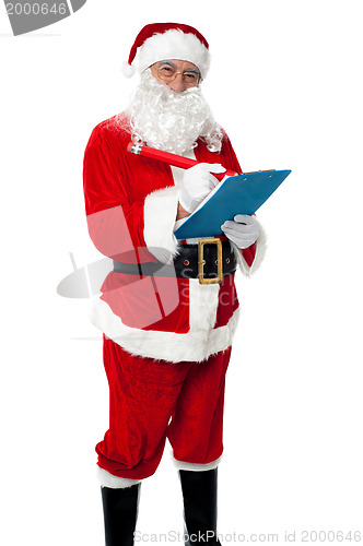 Image of Santa Claus making list of gift recipients